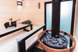 Harvia Legend wood stove installed in a wood sauna with through-glass feeding