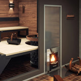 Harvia Legend Duo wood stove feeding through the wall of a modern wood sauna