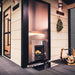 Harvia Legend Duo stove fed from outside a light-wood cabin sauna exterior