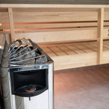 Angled corner view of the Harvia The Wall heater and its dial inside a sauna