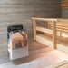 Stainless Harvia The Wall heater installed in a light sauna with wooden benches