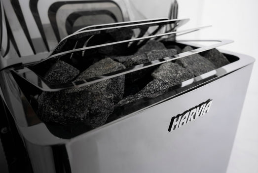 Sauna stones loaded above the Harvia logo on The Wall heater, close detail