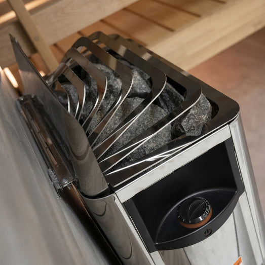 Overhead view of the Harvia The Wall heater stones and dial in a wooden sauna
