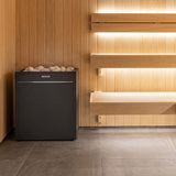 Virta Pro 16kW heater installed in a cedar sauna beside backlit tiered benches
