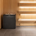 Virta Pro 16kW heater installed in a cedar sauna beside backlit tiered benches