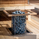 HUUM CLIFF 10.5kW heater floor-mounted with wooden guard rail in a sauna