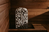 HUUM CLIFF 10.5kW heater set into bench in a warm wooden sauna interior