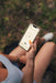 Person controlling the HUUM Cliff heater on the smartphone app while outdoors