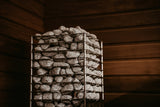 HUUM Cliff heater stones glowing under warm light in a cedar sauna corner