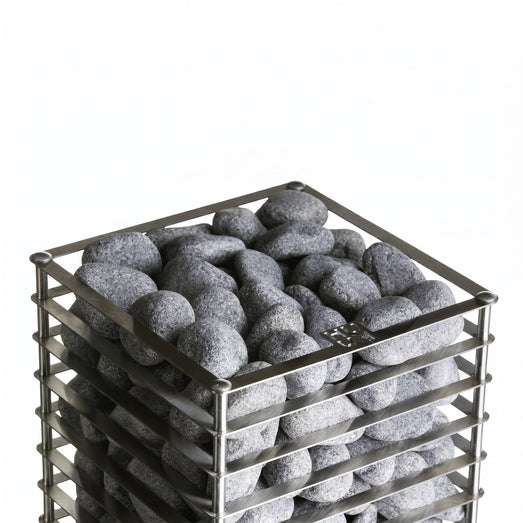 Top-down view of dark sauna stones loaded in the HUUM Cliff heater basket
