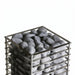 Top-down view of dark sauna stones loaded in the HUUM Cliff heater basket