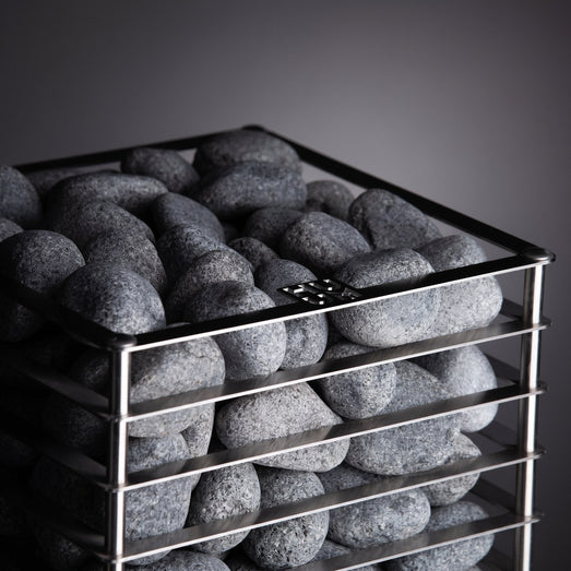 HUUM CLIFF 9kW heater angled view of dark grey stones against charcoal backdrop