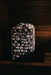 HUUM CLIFF 9kW heater lit dramatically in a dark cedar sauna