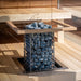 HUUM CLIFF 9kW heater set in a finished sauna with benches and glass wall
