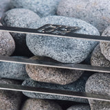 HUUM CLIFF Mini 3.5kW heater close-up of speckled granite stones on the rack