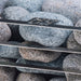 HUUM CLIFF Mini 3.5kW heater close-up of speckled granite stones on the rack