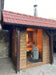 HUUM chimney kit installed on outdoor cabin sauna exterior with stove inside