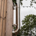 Close-up of HUUM backside chimney stainless pipe, elbow and wall brackets
