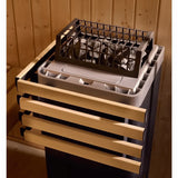 Close-up of the Kohler sauna heater stone bed behind its wood safety rail