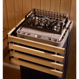Close-up of the Kohler sauna heater stone bed behind its wood safety rail