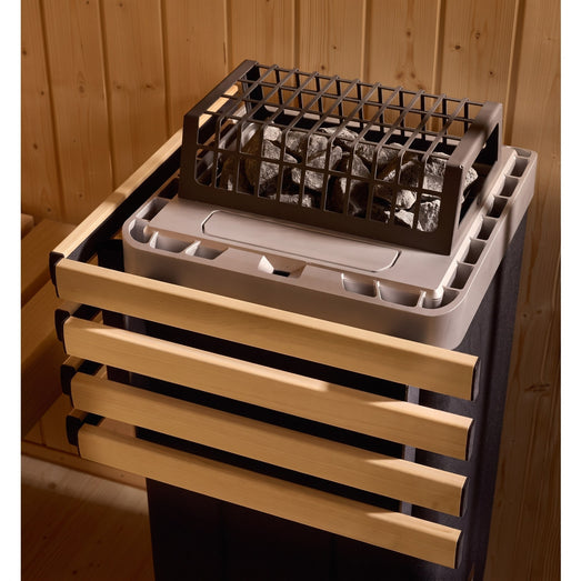 Close-up of the Kohler sauna heater stone bed behind its wood safety rail
