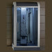 Mesa 500XL steam shower with glass doors lit in a dark wood-paneled room