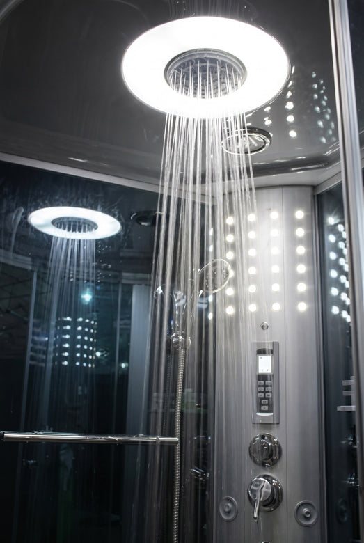 Mesa 802L steam shower rainfall heads running with LED-lit ceiling and panel