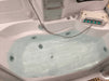 Mesa 807A whirlpool tub filled with water showing chrome jets and headrest