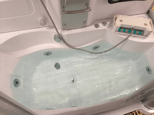 Mesa 807A whirlpool tub filled with water showing chrome jets and headrest