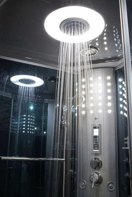 Mesa 9090 steam shower rainfall head running over the lit control panel inside