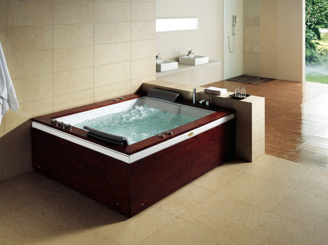 Mesa Monterey BT-0502 wood-trimmed whirlpool tub running in a tiled bathroom
