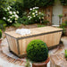 Covered Polar Cold Plunge Tub with towels in a courtyard garden with white hydrangeas