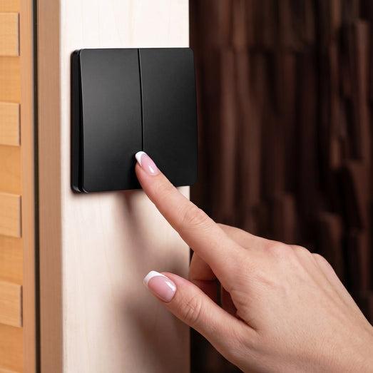 ProSaunas two-button wireless dimming control mounted on a sauna wall