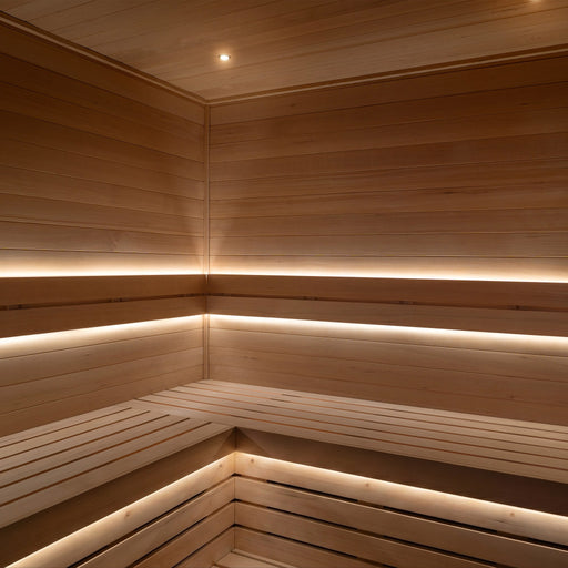 ProSaunas LED strips under the backrest and bench tiers of a light-wood sauna