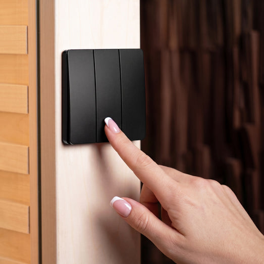ProSaunas three-button wireless dimming control mounted on a sauna wall