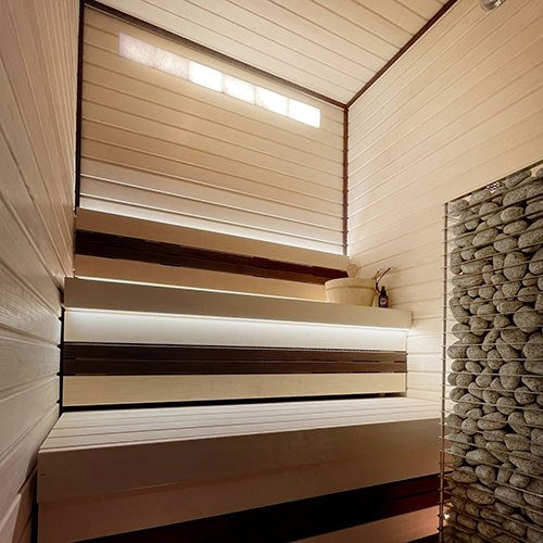 ProSaunas Universal Himalayan Salt Sauna Light Kit, 4 x 48 in: one row of back-lit pink salt bricks recessed high in a sauna wall