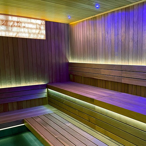 ProSaunas Universal Himalayan Salt Sauna Light Kit, 16 x 48 in: four rows of back-lit pink salt bricks recessed in a sauna wall