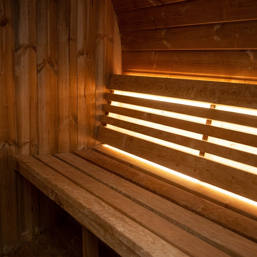 SaunaLife E6 sauna bench with warm LED accent lighting behind the backrest