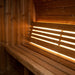 SaunaLife E6 sauna bench with warm LED accent lighting behind the backrest