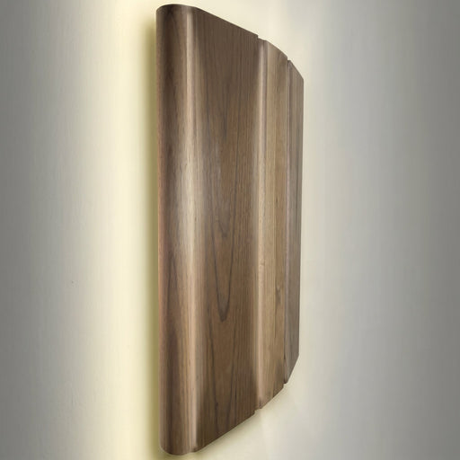 SaunaLife E6 wood sconce light shade casting warm backlit glow at an angle