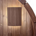 SaunaLife E6 LED sconce bar glowing on cedar barrel sauna interior wall