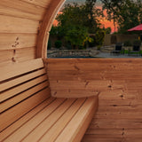 SaunaLife E7 sauna interior bench with rear window framing a sunset backyard patio