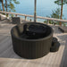 SaunaLife S4 black hot tub overhead view showing molded interior seating on a sea-view deck
