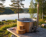 SaunaLife S4 hot tub steaming on a lakeside deck at golden hour with forest backdrop