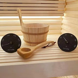 SaunaLife bucket, ladle, thermometer and hygrometer arranged on a cedar sauna bench