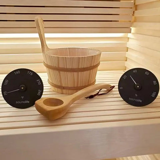 SaunaLife bucket, ladle, thermometer and hygrometer arranged on a cedar sauna bench