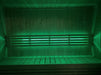 SaunaLife X7MOOD LED bar lighting a sauna interior in vivid green