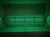 SaunaLife X7MOOD LED bar lighting a sauna interior in vivid green