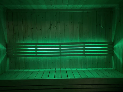 SaunaLife X7MOOD LED bar lighting a sauna interior in vivid green