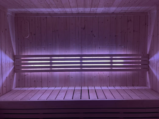SaunaLife X7MOOD LED lighting in magenta illuminating a sauna interior